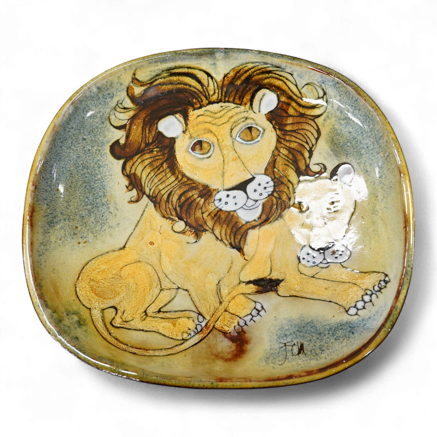 A Joyce Morgan, Chelsea pottery dish depicting a lion and lioness, monogrammed, stamped to the base, 27cm wide